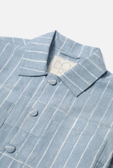 Blue pinstripe shirt with a brand label on a light blue background