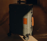 Wingman fern green hardshell suitcase with leather trim and spinner wheels, perfect luxury luggage for premium travel.