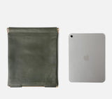 Interior view of the Olive Green Muse Clutch bag Large comfortably fitting an iPad, making it an ideal travel or work accessory.
