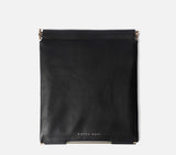 The back profile of the black leather Muse Clutch, highlighting the clean stitching and durable construction of the bag.