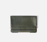 Detail shot of the Olive Green Muse Clutch while folding, revealing the secure closure mechanism and premium lining.