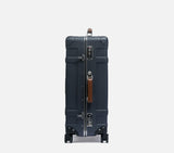 Side profile of the Midnight Blue hardshell luggage, highlighting the secure TSA lock and expandable depth for extra packing.