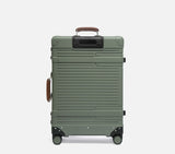 Wingman hardshell check-in suitcase ivory & tan leather accents, spinner wheels, luxury travel trunk lifestyle photography