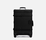 Slate black Wingman hardshell check-in luggage front view with premium leather handle, spinner wheels & TSA lock feature.
