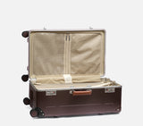 Side profile of a luxury suitcase with TSA locks. This vintage-style hard shell luggage ensures secure, stylish travel