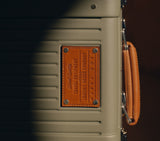 Nappa Dori vintage Wingman luxury luggage. Fern Green hard shell suitcase with leather handle and branded metal plate.