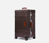 Side profile of a premium hardshell wingman luggage. This luxury suitcase includes secure locks and a vintage leather handle grip