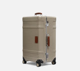 Wingman trunk hardshell suitcase with extended handle in desert sand. A premium spinner suitcase and trunk luggage for business travel professionals.