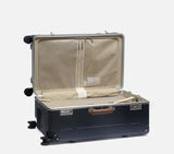 wingman midnight blue luxury luggage trunk with TSA lock and mesh pockets. Premium hardshell suitcase for organized international travel.