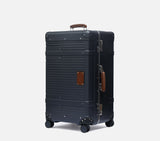 Midnight Blue Wingman trunk highlighting its sleek hard shell structure and compact depth for travel ease