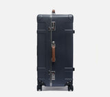 Side view of expandable midnight blue hardshell trunk with aluminum frame and secure TSA lock system for safety.