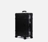 Slate black expandable polycarbonate suitcase side view 26cm depth wheeled travel bag for international flights.